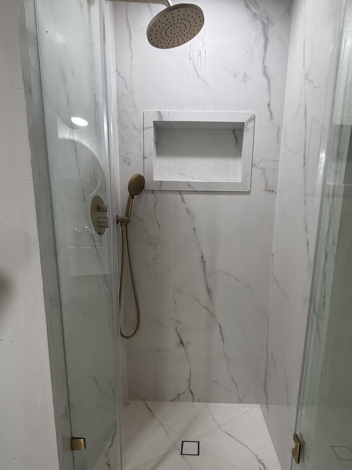 The same bathroom finished in Calacatta Oro porcelain panels